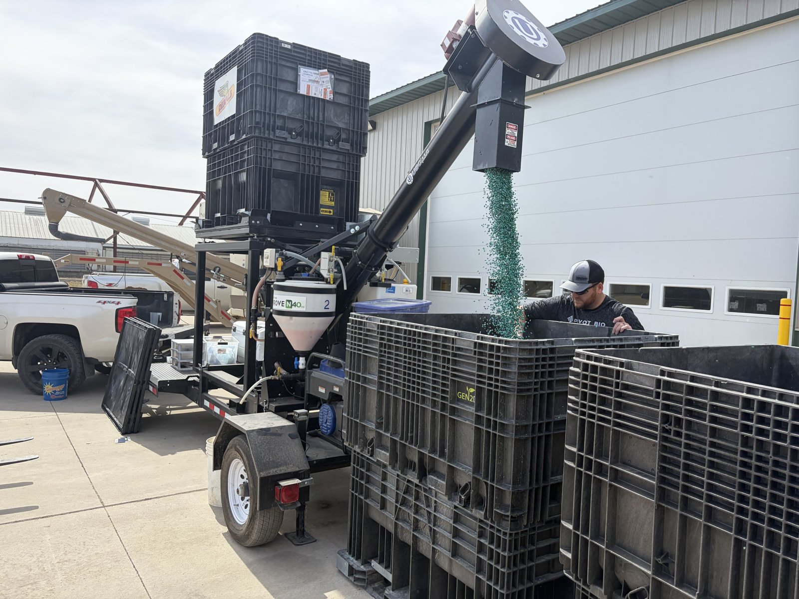 Dinger Sales & Service applying Pivot Bio PROVEN on-seed treatment to seed corn boxes